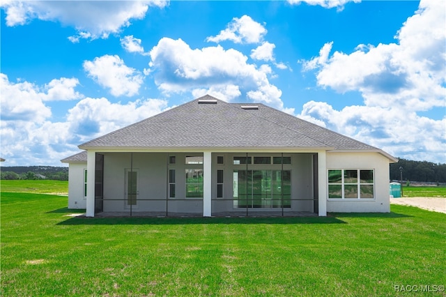 back of property with a lawn