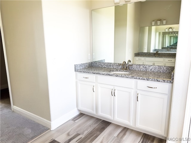 bathroom featuring vanity and hardwood / wood-style flooring