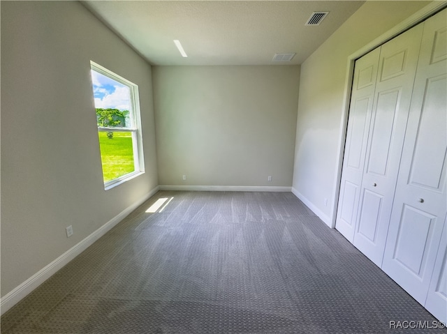 unfurnished bedroom with carpet flooring and a closet