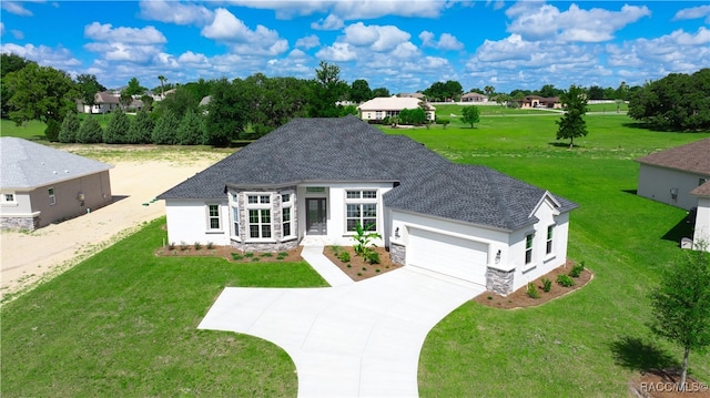 view of front facade featuring a front yard and a garage