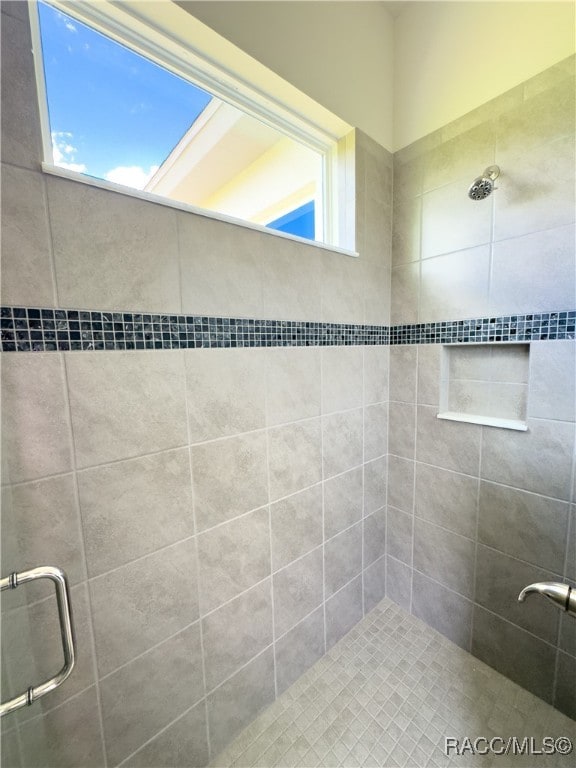 bathroom with a shower with door