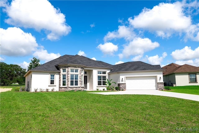 view of front of property with a garage and a front yard