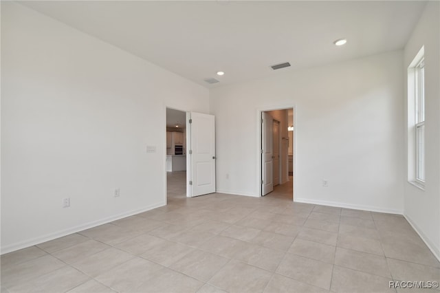 spare room with light tile patterned floors