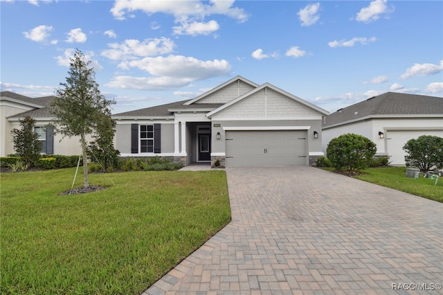 view of front facade with a front yard and a garage