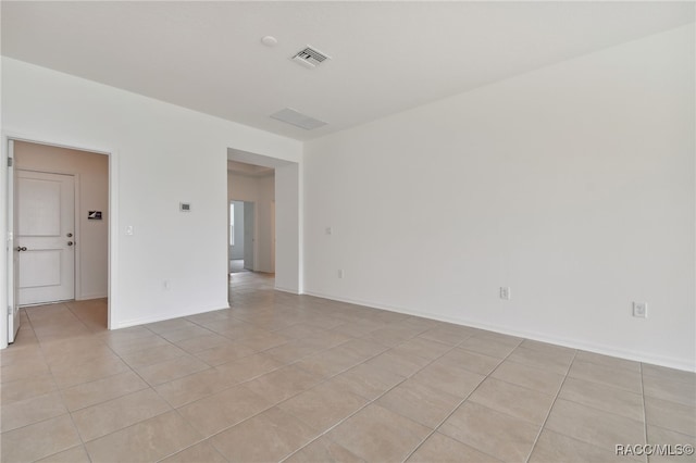 spare room featuring light tile patterned floors