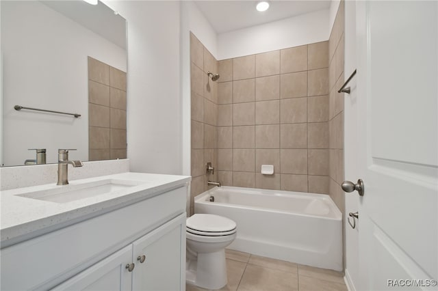 full bathroom with vanity, tiled shower / bath combo, tile patterned floors, and toilet