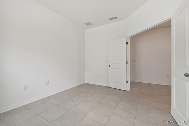 unfurnished room with light tile patterned floors