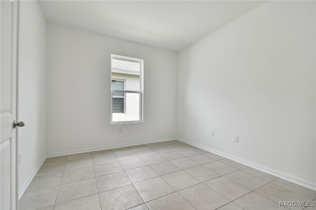 empty room with light tile patterned flooring