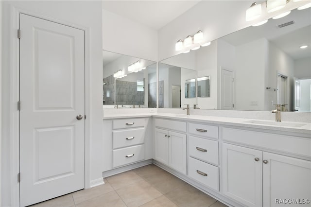 bathroom featuring tile patterned flooring and vanity