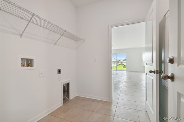 laundry area featuring electric dryer hookup, light tile patterned floors, and hookup for a washing machine