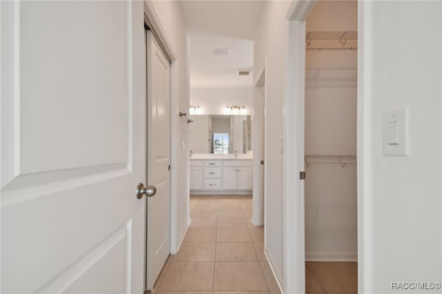 hallway with light tile patterned floors