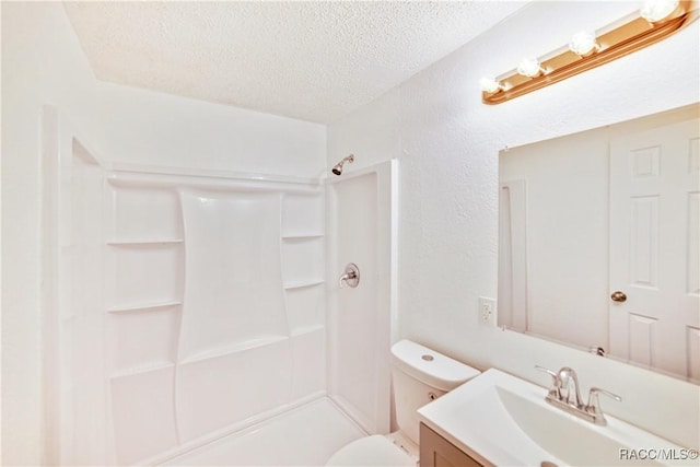 bathroom featuring vanity, toilet, walk in shower, and a textured ceiling