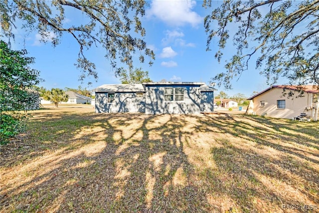 rear view of house with a yard