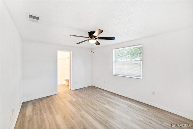 empty room featuring a textured ceiling, ceiling fan, and light hardwood / wood-style floors