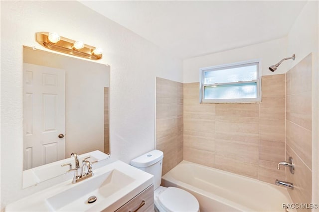 full bathroom with toilet, tiled shower / bath combo, and vanity