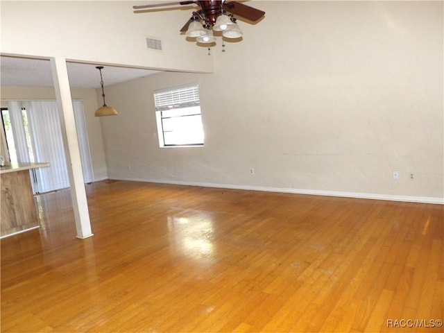 unfurnished living room featuring hardwood / wood-style flooring, a wealth of natural light, and ceiling fan