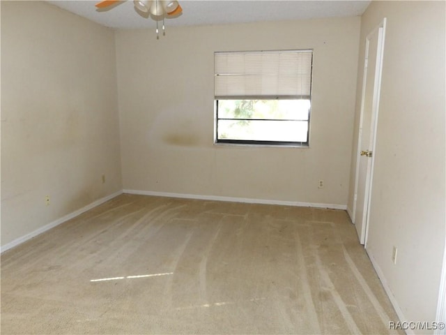 carpeted empty room featuring ceiling fan