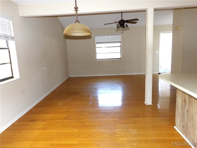 empty room with ceiling fan and light hardwood / wood-style flooring