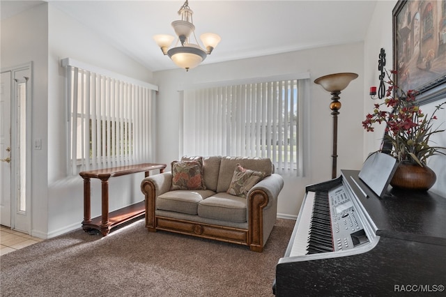 living room with carpet flooring, an inviting chandelier, vaulted ceiling, and a healthy amount of sunlight