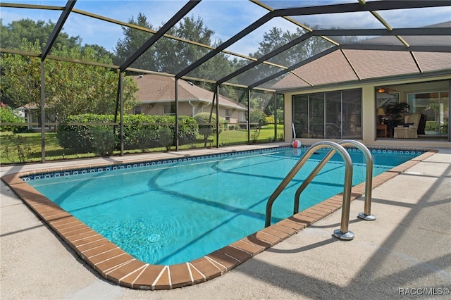 view of swimming pool featuring a patio and glass enclosure