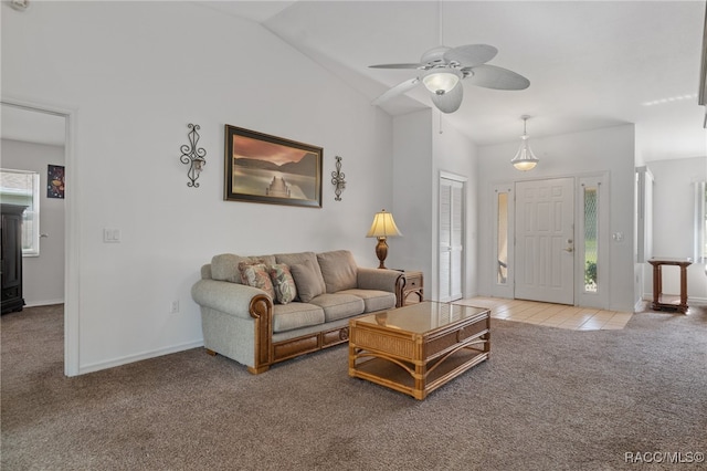 carpeted living room featuring ceiling fan and lofted ceiling