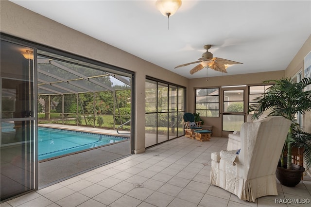 interior space with ceiling fan and a pool