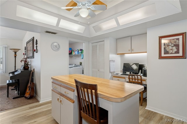 kitchen featuring white cabinets, light hardwood / wood-style floors, and a kitchen island