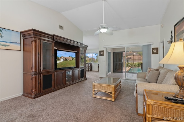 living room with ceiling fan, lofted ceiling, and carpet floors