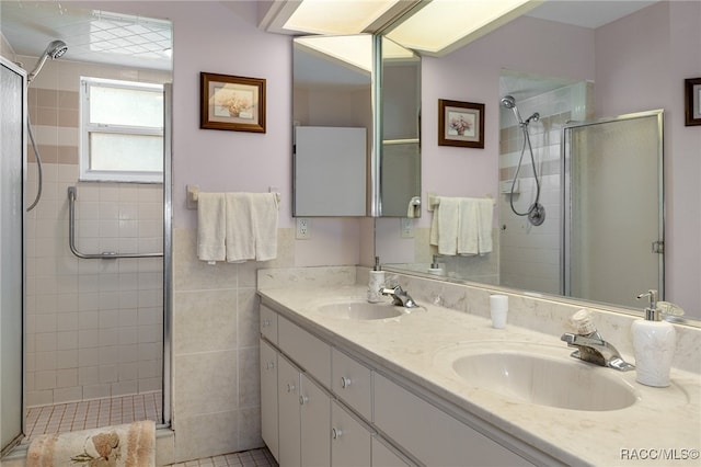 bathroom featuring vanity, tile patterned floors, and walk in shower