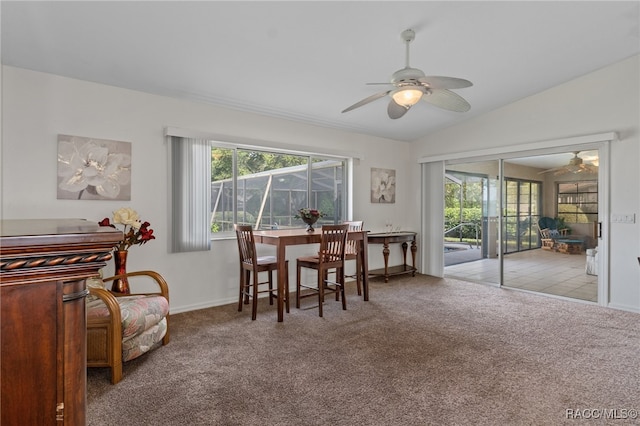 dining area featuring ceiling fan, light colored carpet, and lofted ceiling