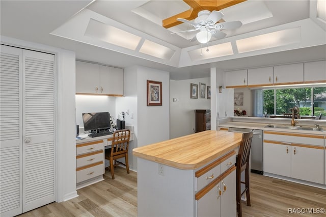 kitchen with white cabinets, a center island, and sink