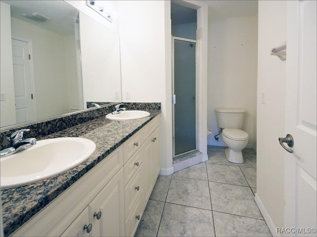 bathroom featuring tile patterned floors, vanity, toilet, and walk in shower