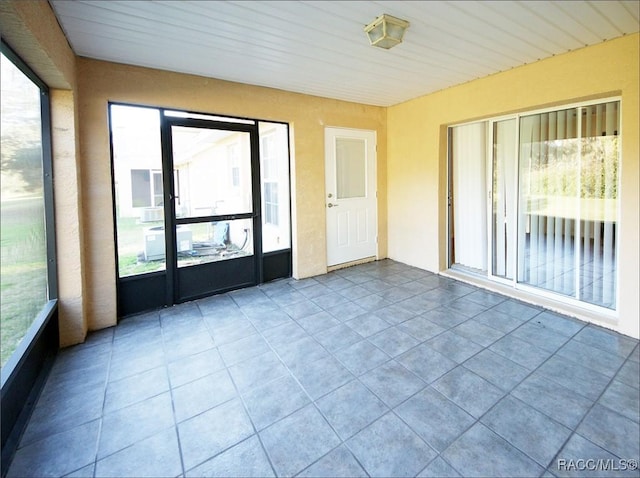 unfurnished sunroom with wooden ceiling