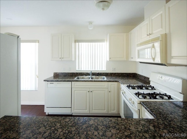 kitchen featuring white cabinetry, sink, and white appliances