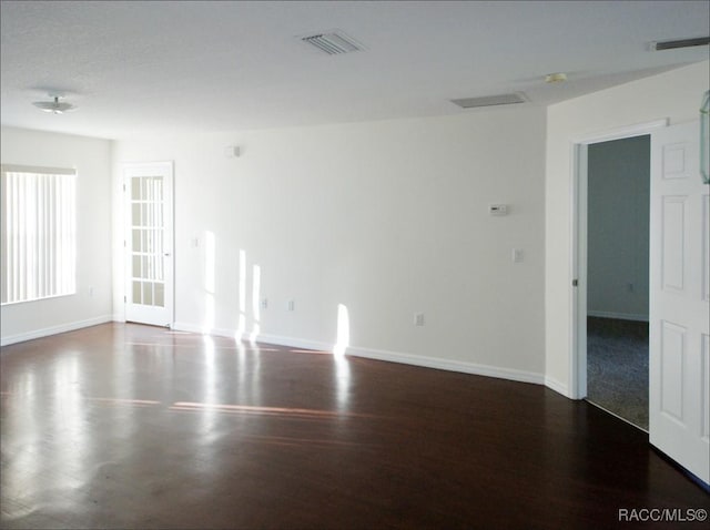 spare room featuring dark hardwood / wood-style flooring