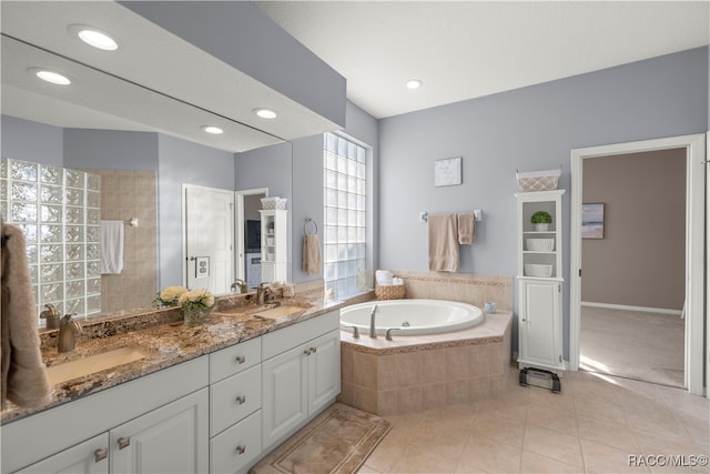 bathroom with tile patterned floors, vanity, and independent shower and bath