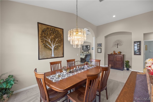 dining room featuring light carpet, a chandelier, and lofted ceiling