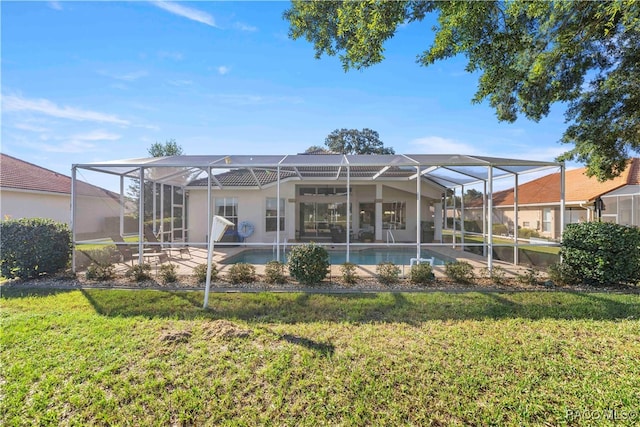 rear view of property featuring glass enclosure and a lawn