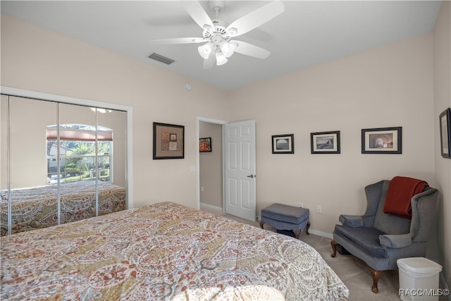 carpeted bedroom featuring a closet and ceiling fan