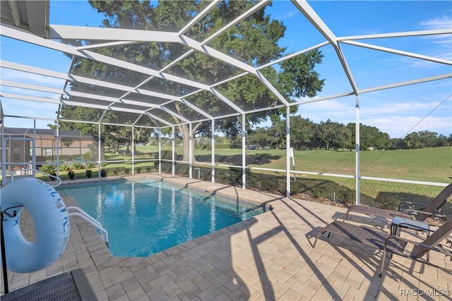 view of pool featuring a patio area, a lanai, and a yard