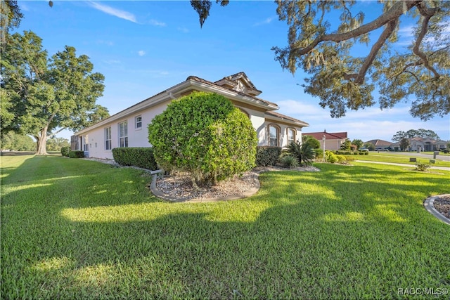 view of property exterior featuring a lawn