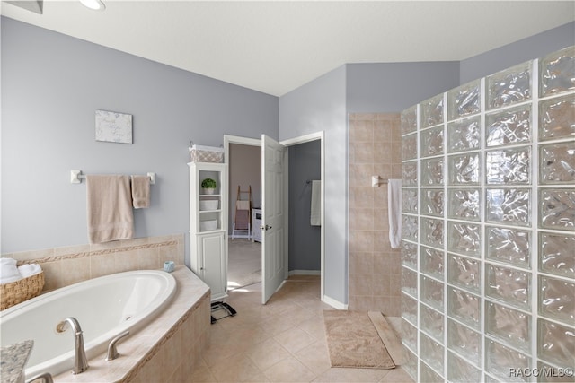 bathroom with tile patterned floors and independent shower and bath