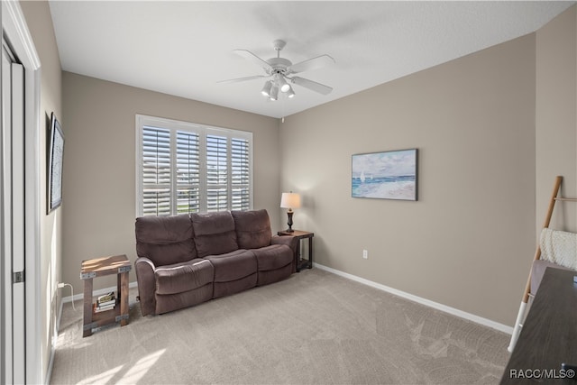 carpeted living room featuring ceiling fan