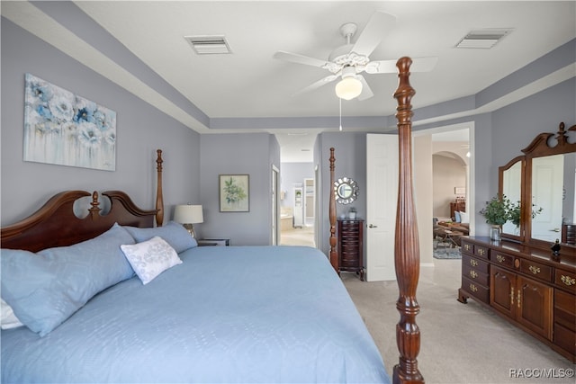 carpeted bedroom with connected bathroom and ceiling fan