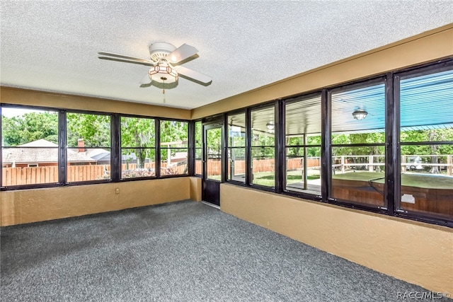 unfurnished sunroom featuring plenty of natural light and ceiling fan