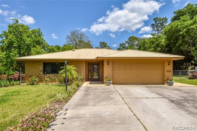 ranch-style home with a garage and a front lawn