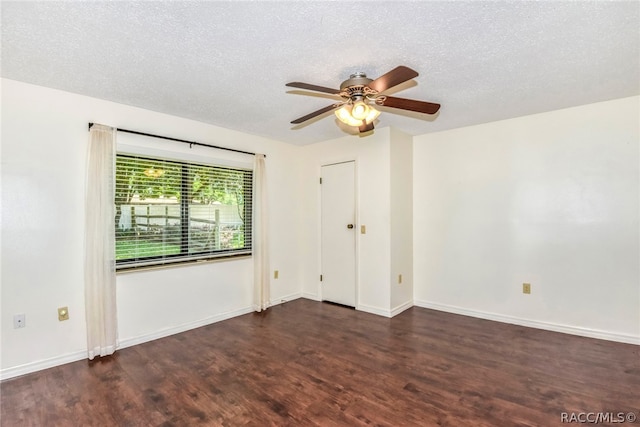 empty room featuring a textured ceiling, ceiling fan, and dark wood-type flooring