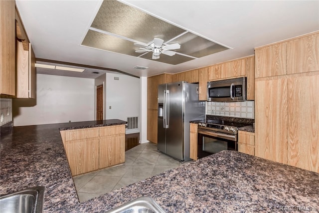 kitchen featuring decorative backsplash, ceiling fan, light tile patterned floors, kitchen peninsula, and stainless steel appliances