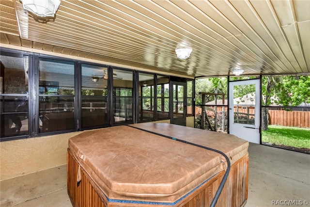 sunroom featuring a jacuzzi