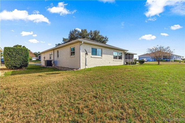 view of property exterior with a lawn and cooling unit